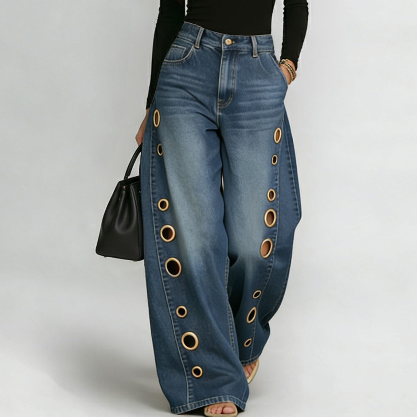 Eleganckie i wygodne jeansy z prostymi nogawkami, ozdobione metalowymi pierścieniami po bokach i wyposażone w kieszenie.