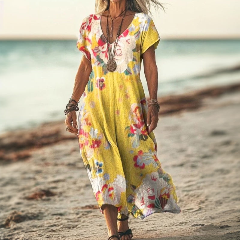 Ta elegancka i wygodna długa sukienka w stylu boho, ozdobiona żółtym wzorem kwiatowym, podkreśli Twój urok.