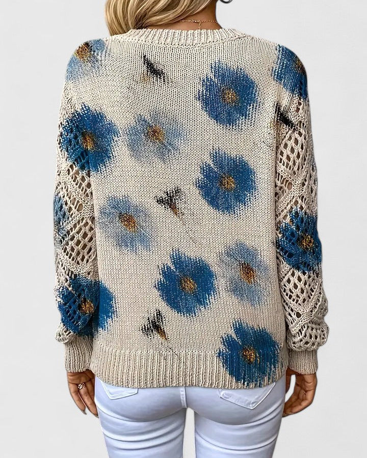 Elegancki i luksusowy top sweter dzianinowy w stylu boho z kwiatowym wzorem, dekoltem w serek, długimi rękawami i ażurowymi rękawami.