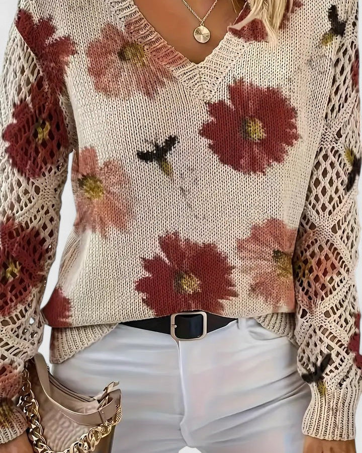 Elegancki i luksusowy top sweter dzianinowy w stylu boho z kwiatowym wzorem, dekoltem w serek, długimi rękawami i ażurowymi rękawami.