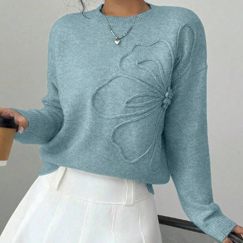 Elegancki i wygodny sweter z miękkiej wełny w jednolitym kolorze, z okrągłym dekoltem i minimalistycznym, a zarazem pięknym wzorem kwiatowym.