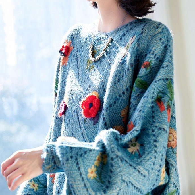 Elegancki i wygodny, dzianinowy sweter w kolorze niebieskim, z okrągłym dekoltem, ażurowym wzorem i kwiatowymi zdobieniami.