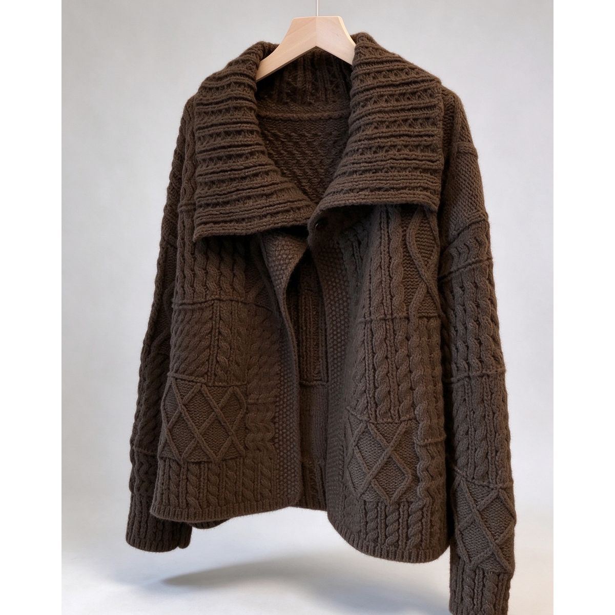 Ten luźny, gruby kardigan o splocie warkoczowym ma luźny kołnierz i miękki, elegancki design.