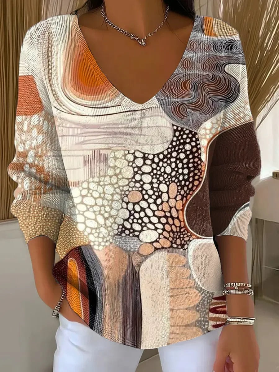 Elegancki i wygodny sweter z długim rękawem w kontrastowych kolorach i dekoltem w serek.