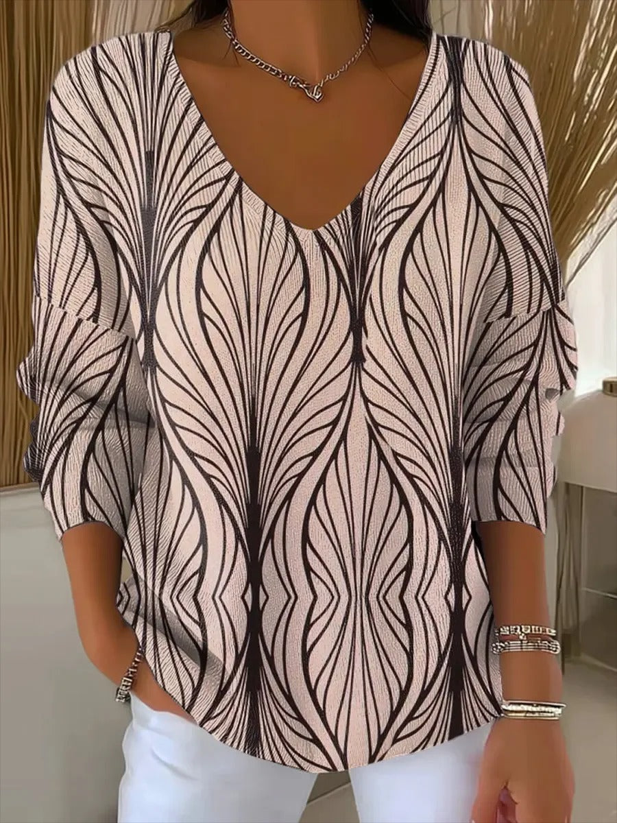Elegancki i wygodny różowy sweter z długim rękawem, ozdobiony nieregularnym wzorem i dekoltem w serek.