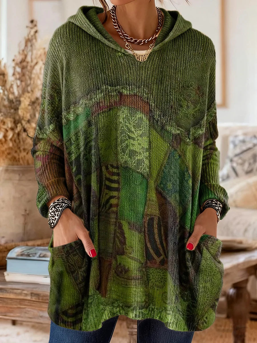 Elegancki i wygodny zielony sweter kaszmirowy ozdobiony delikatnym kwiatowym nadrukiem, z kapturem i kieszeniami.