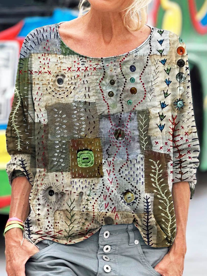 Elegancki i wygodny top z okrągłym dekoltem w bloki kolorów, ozdobiony minimalistycznym nadrukiem kwiatowym.