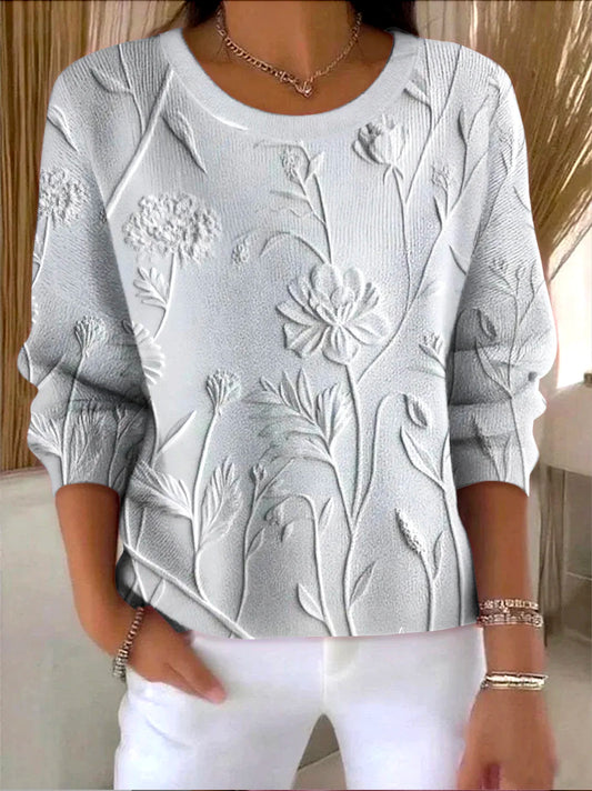 Elegancki i wygodny szary sweter z długim rękawem i okrągłym dekoltem, ozdobiony trójwymiarowym kwiatowym wzorem.