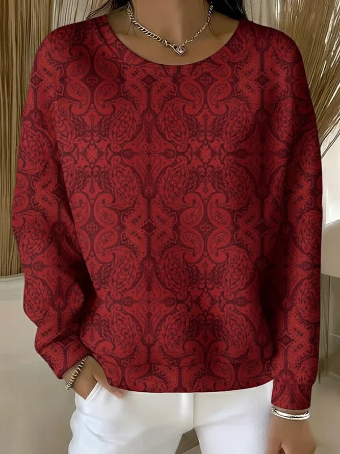 Elegancki i wygodny sweter z długim rękawem i okrągłym dekoltem, ozdobiony pięknym kwiatowym nadrukiem.