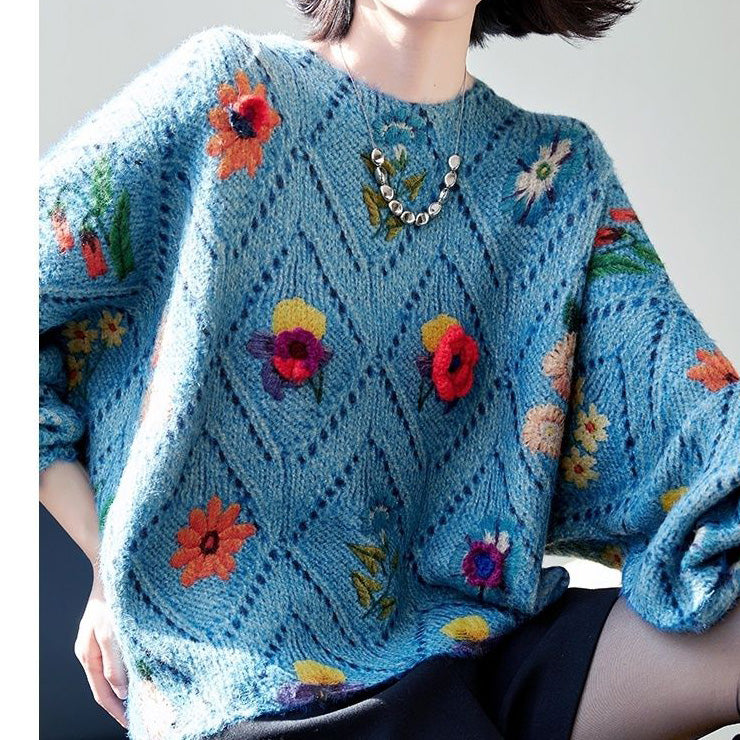 Elegancki i wygodny, dzianinowy sweter w kolorze niebieskim, z okrągłym dekoltem, ażurowym wzorem i kwiatowymi zdobieniami.