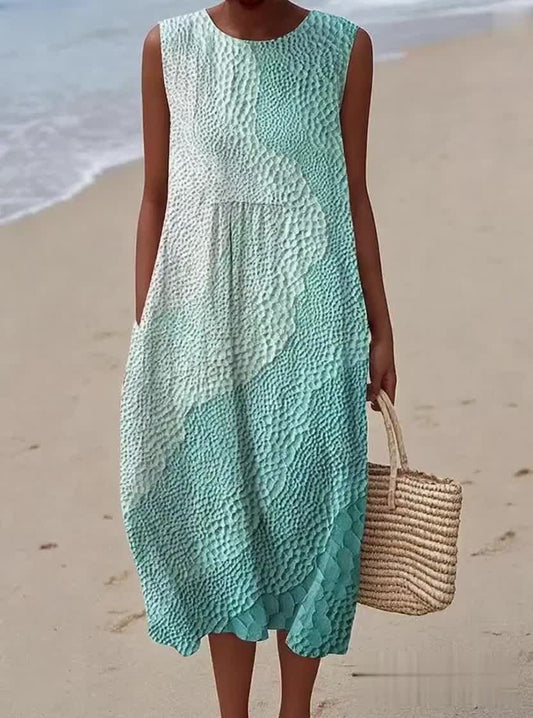 Elegancka i wygodna sukienka bez rękawów z kolorowym gradientem, odpowiednia zarówno na wakacje, jak i dojazdy do pracy.