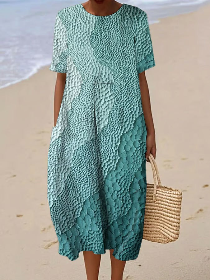 Elegancka i wygodna sukienka z krótkim rękawem w kolorowym gradiencie, lekka i zwiewna.