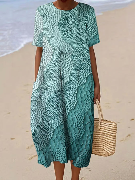 Elegancka i wygodna sukienka z krótkim rękawem w kolorowym gradiencie, lekka i zwiewna.