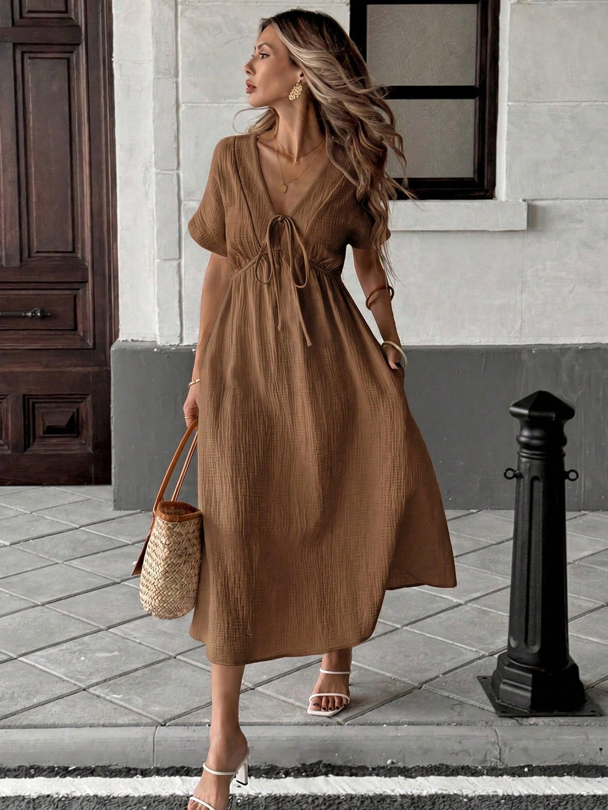 Ta elegancka sukienka z dekoltem w serek ma dopasowaną talię i emanuje swobodną, a zarazem stylową atmosferą.