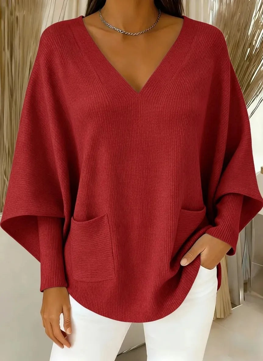 Ten stylowy sweter z dekoltem w serek ma luźny, swobodny krój i dopasowane mankiety, dzięki czemu wygląda świeżo i atrakcyjnie.