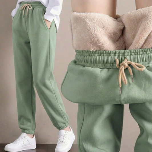 Te eleganckie i wygodne damskie spodnie dresowe o swobodnym kroju są wykonane z grubej wełnianej tkaniny i idealnie nadają się do noszenia jesienią i zimą.