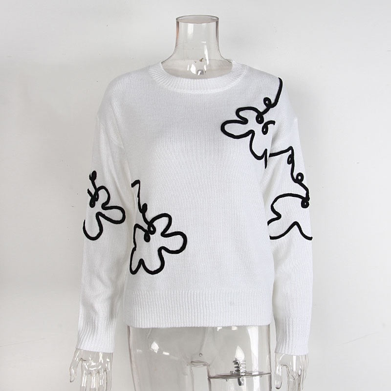 Elegancki i wygodny sweter z okrągłym dekoltem i minimalistycznym wzorem kwiatowym
