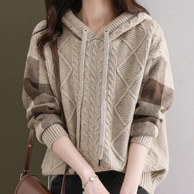 Elegancki i wygodny damski sweter z kapturem wykonany z dzianiny, ozdobiony delikatnym wzorem kwiatowym.