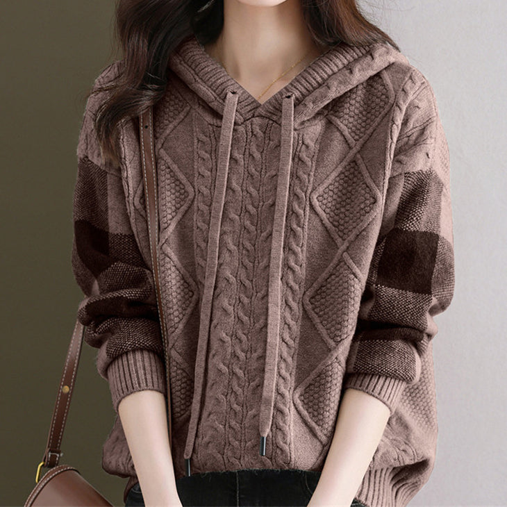 Elegancki i wygodny damski sweter z kapturem wykonany z dzianiny, ozdobiony delikatnym wzorem kwiatowym.