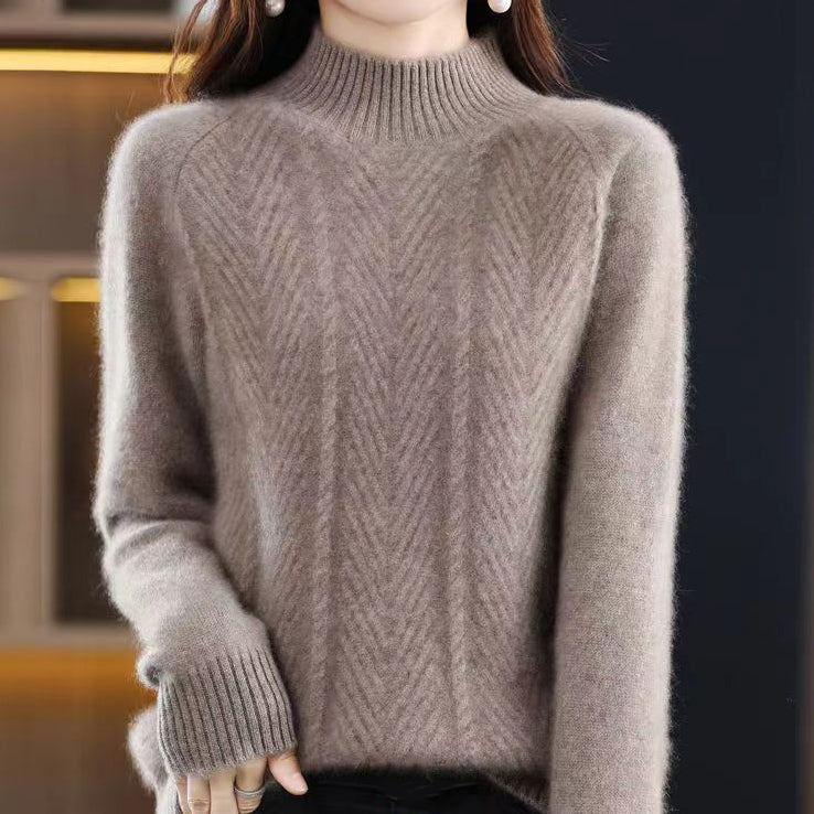 Elegancki i wygodny golf w jednolitym kolorze, ozdobiony tkanym, skręconym wzorem.