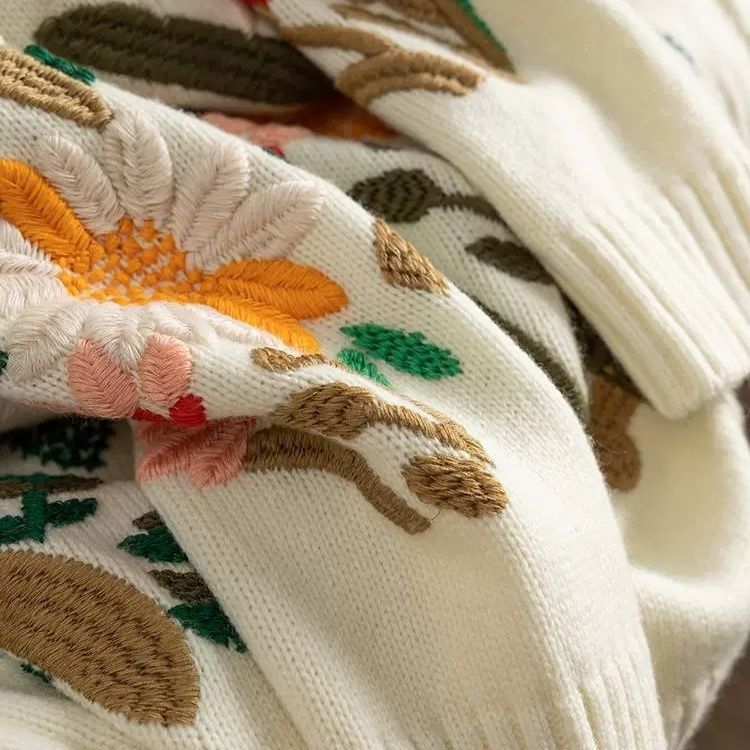 Elegancki i wygodny sweter z haftowanym kwiatowym wzorem i okrągłym dekoltem oraz długimi rękawami, który zapewnia swobodny i szykowny wygląd