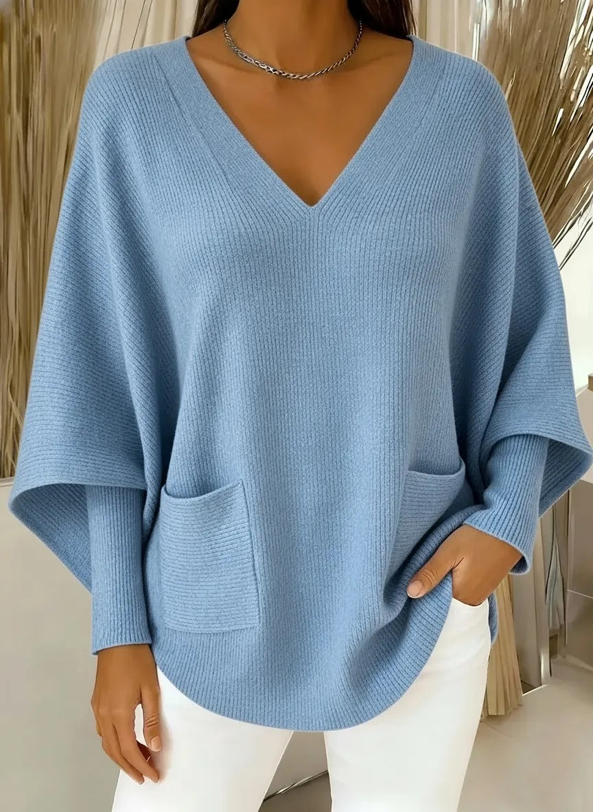 Ten stylowy sweter z dekoltem w serek ma luźny, swobodny krój i dopasowane mankiety, dzięki czemu wygląda świeżo i atrakcyjnie.