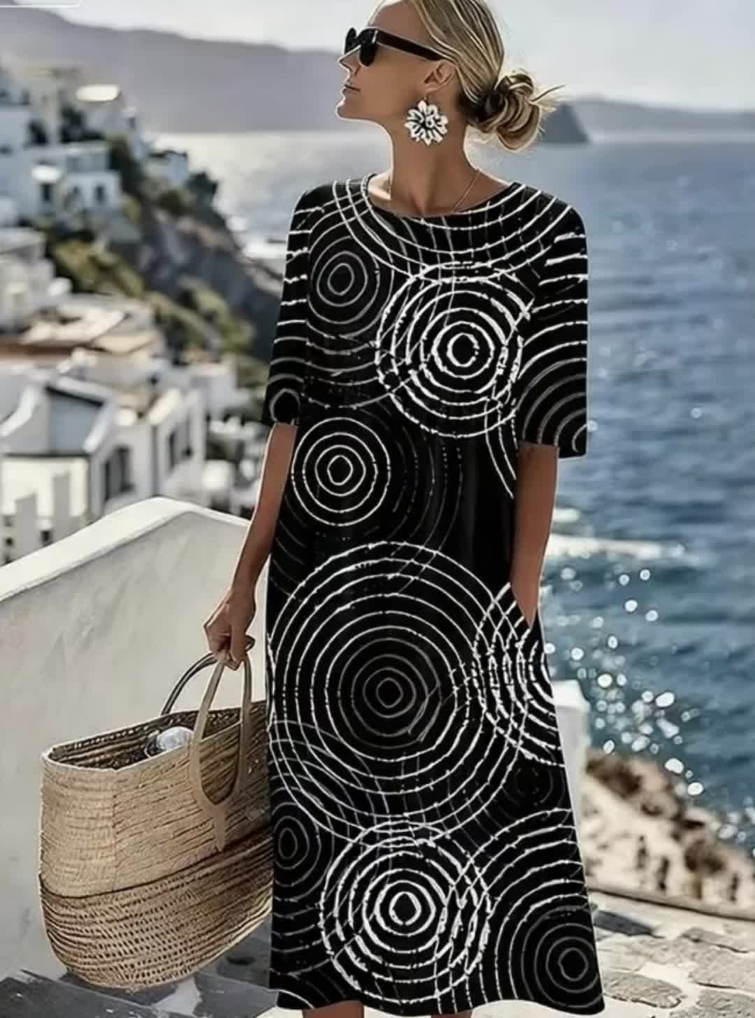 Wygodna czarna sukienka bez rękawów ozdobiona jest nieregularnym geometrycznym wzorem, który podkreśla jej wyrafinowany i elegancki styl.