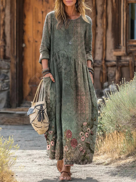 Elegancka i wygodna bawełniana sukienka w kolorze niebiesko-szarym z kwiatowym nadrukiem, długimi rękawami i kieszeniami bocznymi.