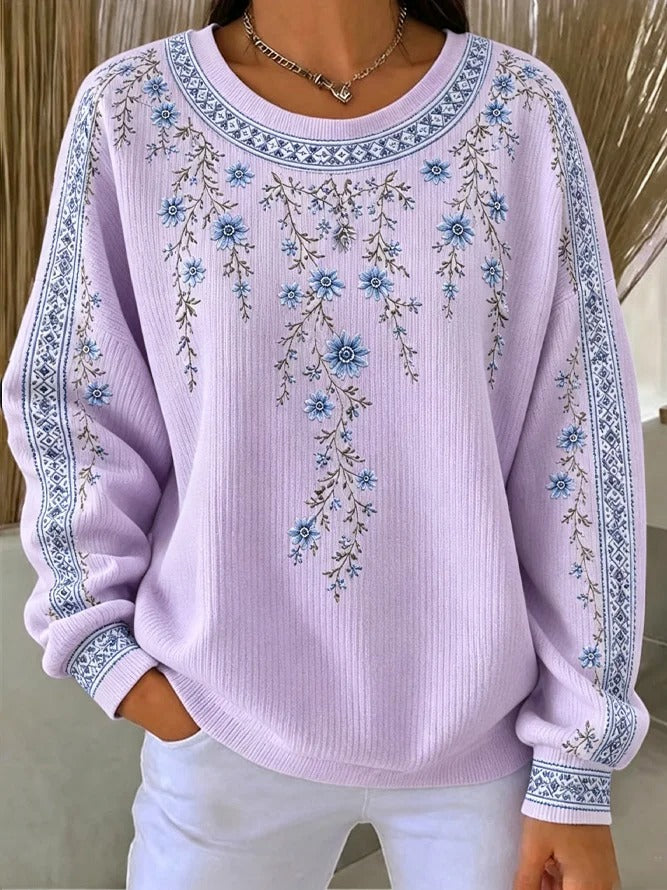 Ten sweter z okrągłym dekoltem jest elegancki i wygodny, ozdobiony delikatnym kwiatowym wzorem i ma swobodny, uniwersalny styl.