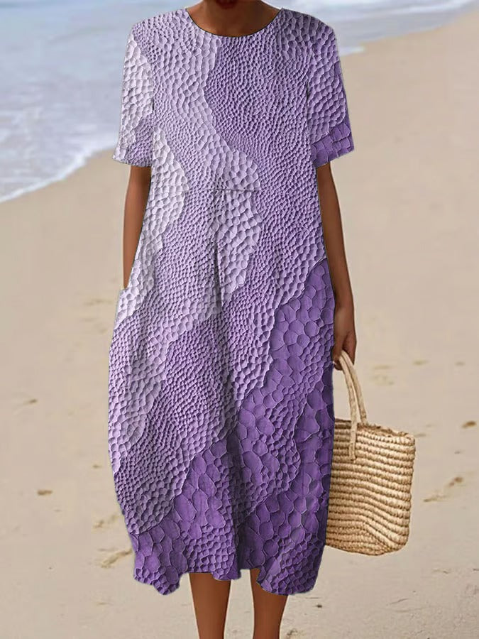 Elegancka i wygodna sukienka z krótkim rękawem w kolorowym gradiencie, lekka i zwiewna.