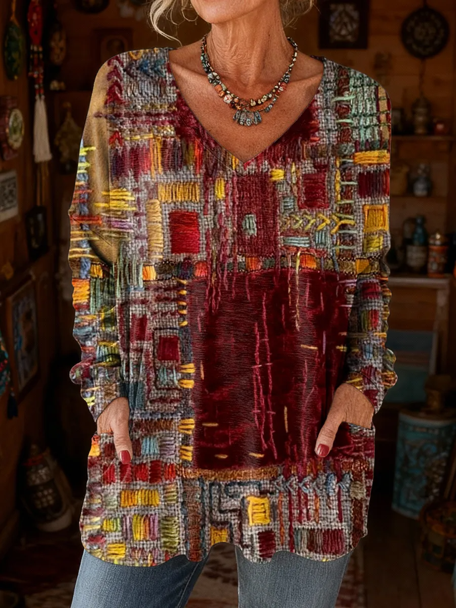 Elegancki i wygodny sweter z kaszmiru z dekoltem w serek, ozdobiony nieregularnym wzorem w bloki kolorystyczne i kieszeniami.