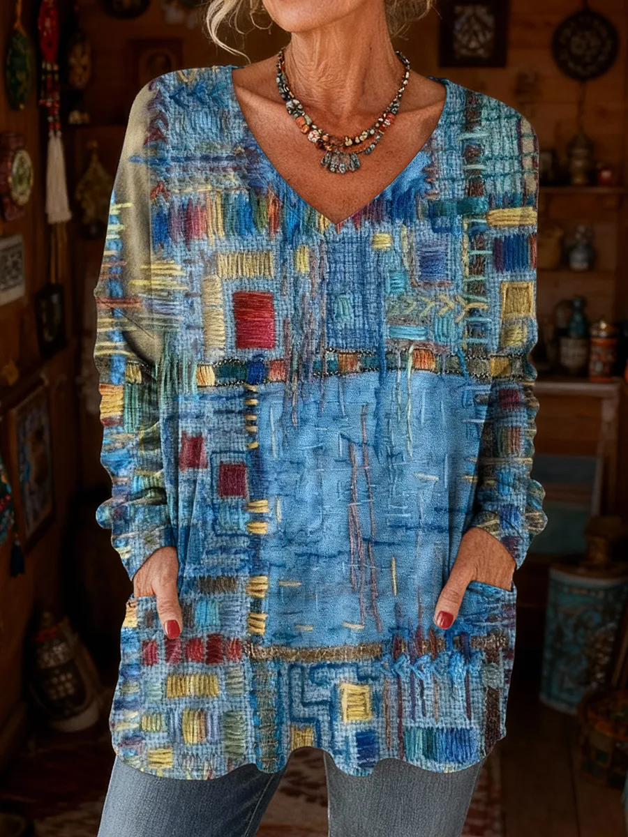 Elegancki i wygodny sweter z kaszmiru z dekoltem w serek, ozdobiony nieregularnym wzorem w bloki kolorystyczne i kieszeniami.