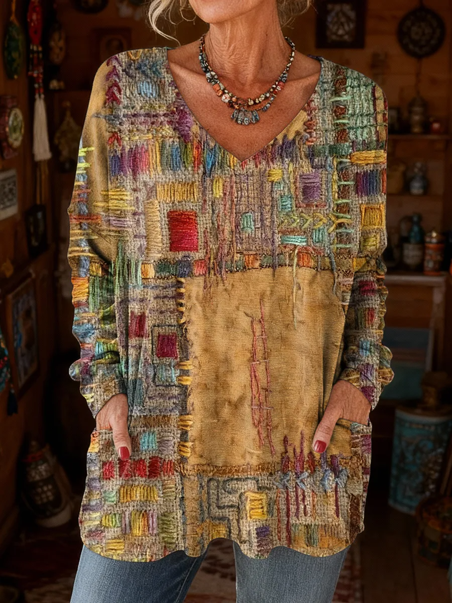 Elegancki i wygodny sweter z kaszmiru z dekoltem w serek, ozdobiony nieregularnym wzorem w bloki kolorystyczne i kieszeniami.