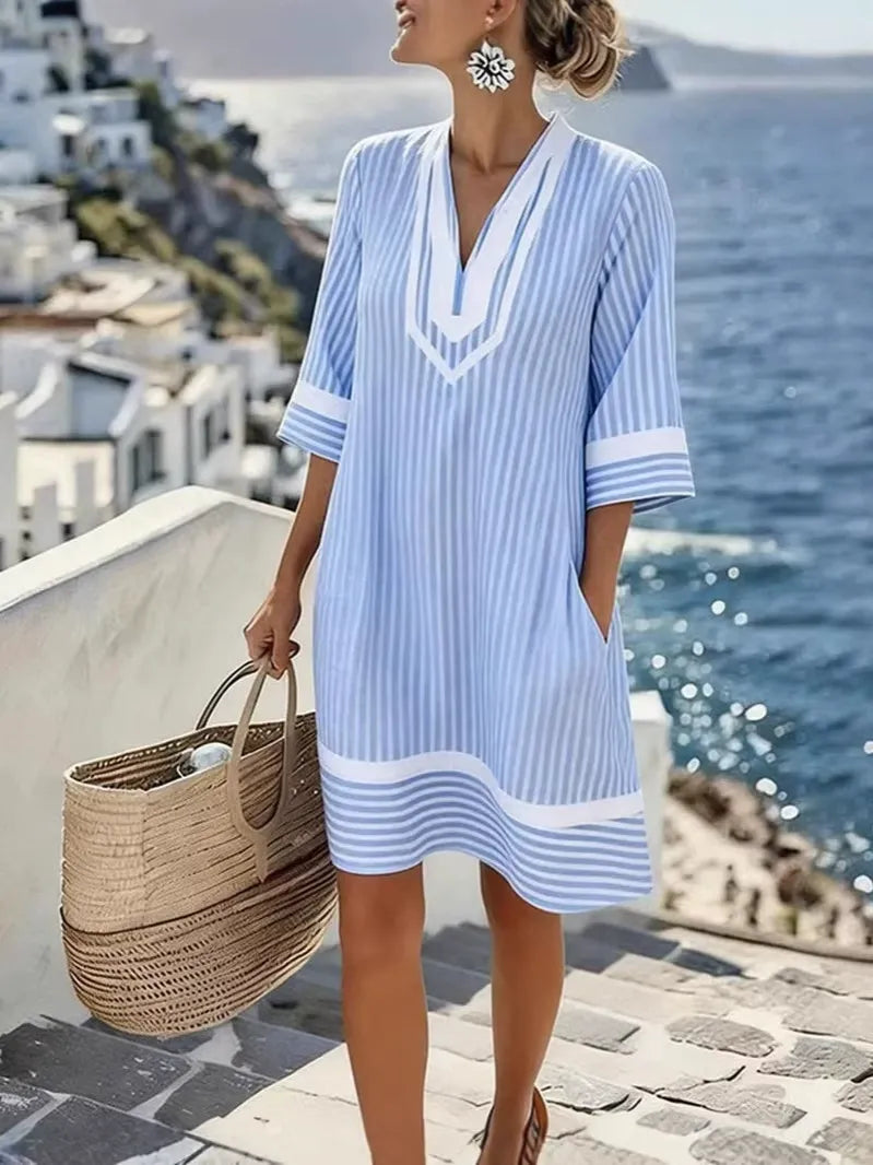 Nowa damska sukienka z dekoltem w serek, wzorem w paski i kieszeniami.