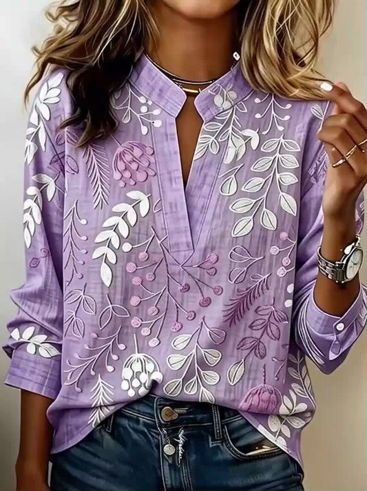 Ta elegancka fioletowa koszula ma stójkę i kwiatowy nadruk, dzięki czemu jest wygodna i uniwersalna.