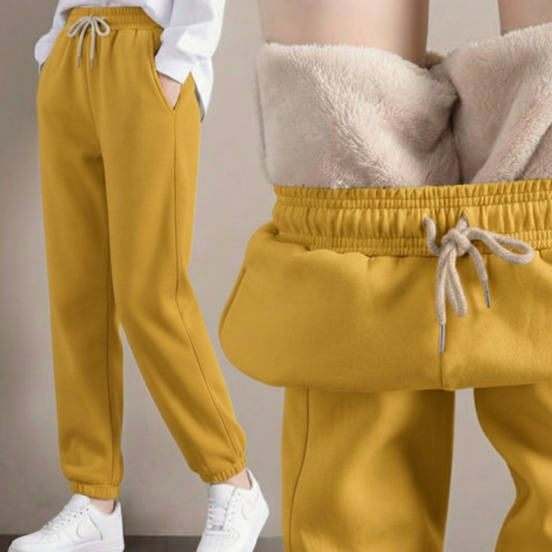 Te eleganckie i wygodne damskie spodnie dresowe o swobodnym kroju są wykonane z grubej wełnianej tkaniny i idealnie nadają się do noszenia jesienią i zimą.